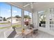 Serene sunroom with comfortable seating and expansive windows offering a great view at 9312 Se 172Nd Wayside Pl, The Villages, FL 32162