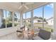 Bright sunroom with comfortable seating and large windows offering a great view at 9312 Se 172Nd Wayside Pl, The Villages, FL 32162