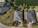 Aerial view of well-maintained homes with lush lawns and a serene pond in a desirable neighborhood at 10173 Julia Isles Ave, Oxford, FL 34484
