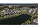 Aerial view featuring a pond surrounded by homes in a quiet, Gathering-friendly community at 10173 Julia Isles Ave, Oxford, FL 34484