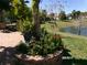 Brick paved patio with seating, potted plants and lake view at 10173 Julia Isles Ave, Oxford, FL 34484
