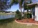 Well maintained backyard with tropical plants, a pond view and lovely landscape design at 10173 Julia Isles Ave, Oxford, FL 34484