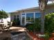 Beautiful backyard with a brick patio, lush tropical landscaping and exterior access at 10173 Julia Isles Ave, Oxford, FL 34484