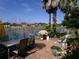 Brick patio, table and chairs, grill with a peaceful lake view at 10173 Julia Isles Ave, Oxford, FL 34484