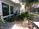 Charming patio area with a tranquil water feature, providing a serene backyard setting with lush plants and comfortable seating at 10173 Julia Isles Ave, Oxford, FL 34484