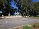Outdoor basketball court with mature trees providing shade for players at 10173 Julia Isles Ave, Oxford, FL 34484