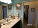 Bright bathroom with a white countertop vanity, featuring modern fixtures and tasteful decor at 10173 Julia Isles Ave, Oxford, FL 34484