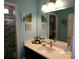Bathroom with a sleek white vanity, modern sink, and stylish accents, providing a clean and bright space at 10173 Julia Isles Ave, Oxford, FL 34484