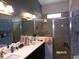 The bathroom features a shower and double sink at 10173 Julia Isles Ave, Oxford, FL 34484
