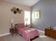 Charming bedroom showcasing stylish accents, a cozy bed and a sunny window at 10173 Julia Isles Ave, Oxford, FL 34484