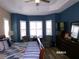 This bedroom has a ceiling fan and natural light at 10173 Julia Isles Ave, Oxford, FL 34484