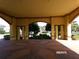 View of the covered entrance with tan columns and a brick pattern drive at 10173 Julia Isles Ave, Oxford, FL 34484