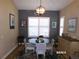 Bright dining area featuring a glass table, stylish chairs, and shuttered windows for natural light and comfortable dining at 10173 Julia Isles Ave, Oxford, FL 34484