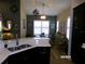 Open concept kitchen and dining area with hardwood flooring and natural lighting at 10173 Julia Isles Ave, Oxford, FL 34484