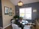 Dining room with round glass table and bright lighting at 10173 Julia Isles Ave, Oxford, FL 34484