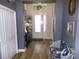 Inviting entryway with light wood flooring, white door, high ceiling, and blue-gray walls at 10173 Julia Isles Ave, Oxford, FL 34484