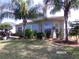 Beautifully landscaped home featuring well-manicured lawn, vibrant plants, and a cozy patio area ideal for enjoying outdoors at 10173 Julia Isles Ave, Oxford, FL 34484