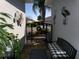 Charming house entrance features a decorative gate and plants, with a bench and decorations to greet guests at 10173 Julia Isles Ave, Oxford, FL 34484