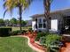 Single-story home boasts lush landscaping, a brick driveway, and charming curb appeal at 10173 Julia Isles Ave, Oxford, FL 34484