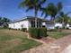 Charming home featuring mature landscaping and a well-maintained lawn on a sunny day at 10173 Julia Isles Ave, Oxford, FL 34484