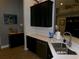Well-equipped kitchen with black cabinetry, stone countertops, and modern fixtures at 10173 Julia Isles Ave, Oxford, FL 34484
