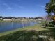 Picturesque lake view surrounded by well-maintained lawns and neighboring homes, offering a peaceful and scenic living environment at 10173 Julia Isles Ave, Oxford, FL 34484