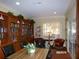 Beautiful library featuring floor-to-ceiling bookshelves, comfortable seating, and bright natural light at 10173 Julia Isles Ave, Oxford, FL 34484