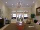 Well-appointed lobby area with a chandelier, comfortable seating, a fireplace, and decorative accents at 10173 Julia Isles Ave, Oxford, FL 34484