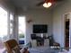 Cozy sun room with a comfortable recliner, large windows, and a mounted TV, perfect for relaxing at 10173 Julia Isles Ave, Oxford, FL 34484