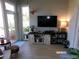 Bright sun room with large windows, decorative butterfly, and comfortable seating area at 10173 Julia Isles Ave, Oxford, FL 34484