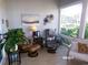 Relaxing sunroom with a view, offers comfortable seating and natural light at 10173 Julia Isles Ave, Oxford, FL 34484