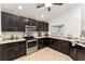 Well-lit kitchen with dark cabinets, stainless steel appliances, and granite countertops at 10396 Silver Maple Ave, Oxford, FL 34484