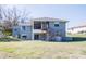 Two-story home exterior with a wooden deck and walkout basement at 10648 Lake Hill Dr, Clermont, FL 34711