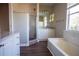 Bathroom with a shower, bath, cabinets, and a window for natural lighting at 10648 Lake Hill Dr, Clermont, FL 34711