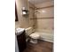 Bathroom featuring tiled walls, toilet, and sink with dark wood vanity at 10648 Lake Hill Dr, Clermont, FL 34711