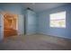 A bedroom painted blue features carpeted floors and a storage shelf at 10648 Lake Hill Dr, Clermont, FL 34711