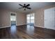 Bedroom with laminate flooring, ceiling fan, and sliding glass doors to the balcony at 10648 Lake Hill Dr, Clermont, FL 34711