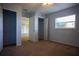 Well-lit bedroom with light blue walls, carpet flooring, and access to an attached closet at 10648 Lake Hill Dr, Clermont, FL 34711
