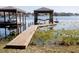 Dock over water with boat and boat lift at 10648 Lake Hill Dr, Clermont, FL 34711