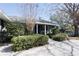 Charming front entrance with covered porch, lush landscaping, and a clear view of the home's facade at 10648 Lake Hill Dr, Clermont, FL 34711