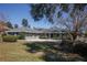 Charming one-story home featuring a manicured front lawn and a spacious driveway at 10648 Lake Hill Dr, Clermont, FL 34711