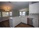 Kitchen island with stainless steel dishwasher and a view of the water through the windows at 10648 Lake Hill Dr, Clermont, FL 34711