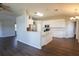 Bright kitchen with stainless steel appliances, white cabinets, and an island with countertop at 10648 Lake Hill Dr, Clermont, FL 34711