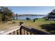 Picturesque lake view from the backyard featuring a serene waterfront panorama and lush landscaping at 10648 Lake Hill Dr, Clermont, FL 34711
