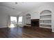 Spacious living room features a brick fireplace, custom built-ins, and natural light from large windows at 10648 Lake Hill Dr, Clermont, FL 34711