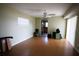 Well-lit living room with cork flooring and access to kitchen at 10648 Lake Hill Dr, Clermont, FL 34711