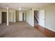 Spacious living room featuring neutral carpet and paint, with access to stairs and closets at 10648 Lake Hill Dr, Clermont, FL 34711