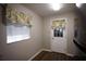 Mud room with a white door, window, and view of the backyard through the window at 10648 Lake Hill Dr, Clermont, FL 34711