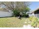 Backyard featuring a fire pit, mature trees, and a fenced perimeter at 10910 Rushwood Way, Clermont, FL 34714