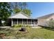 Well-maintained backyard featuring a screened lanai and a fire pit area at 10910 Rushwood Way, Clermont, FL 34714